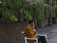 People wearing a protective mask walk in Jakarta, Indonesia, on May 18, 2022 amid the COVID-19 pandemic. (