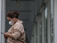 People wearing a protective mask walk in Jakarta, Indonesia, on May 18, 2022 amid the COVID-19 pandemic. (