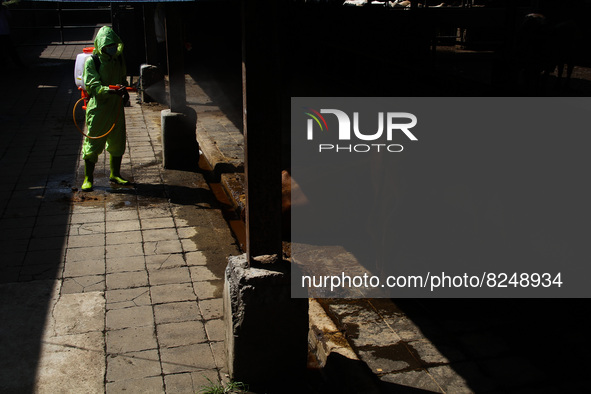 An officer is seen spraying disinfectant in the cage area to prevention of the Spread of Mouth and Nail Disease (PMK) on May 18, 2022, in Ba...