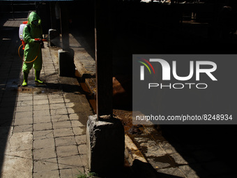 An officer is seen spraying disinfectant in the cage area to prevention of the Spread of Mouth and Nail Disease (PMK) on May 18, 2022, in Ba...