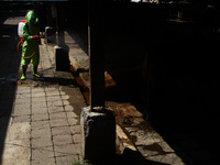 An officer is seen spraying disinfectant in the cage area to prevention of the Spread of Mouth and Nail Disease (PMK) on May 18, 2022, in Ba...