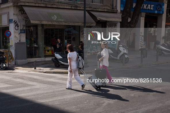 Two women with suitcase are walking near Monastiraki square in Athens, Greece on May 18, 2022. A committee of experts from the Health Minist...