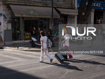 Two women with suitcase are walking near Monastiraki square in Athens, Greece on May 18, 2022. A committee of experts from the Health Minist...