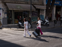 Two women with suitcase are walking near Monastiraki square in Athens, Greece on May 18, 2022. A committee of experts from the Health Minist...