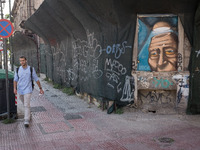 A man is passing in front of a graffiti in Athens, Greece on May 18, 2022. A committee of experts from the Health Ministry are examining the...