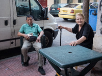 A elderly woman and a man are sitted outside a store in Athens, Greece on May 18, 2022. A committee of experts from the Health Ministry are...