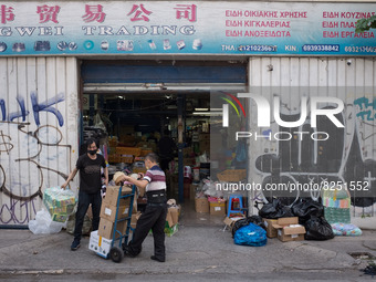 People are working outside a store in Athens, Greece on May 18, 2022. A committee of experts from the Health Ministry are examining the poss...