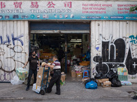 People are working outside a store in Athens, Greece on May 18, 2022. A committee of experts from the Health Ministry are examining the poss...