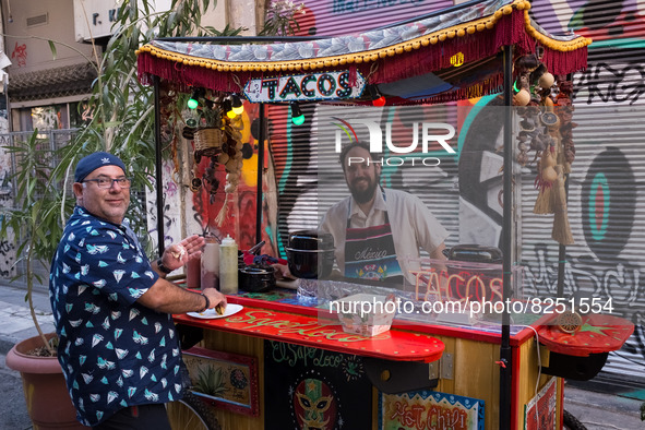 A man selling tacos is posing for a photo in Athens, Greece on May 18, 2022. A committee of experts from the Health Ministry are examining t...