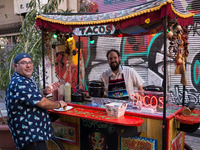 A man selling tacos is posing for a photo in Athens, Greece on May 18, 2022. A committee of experts from the Health Ministry are examining t...