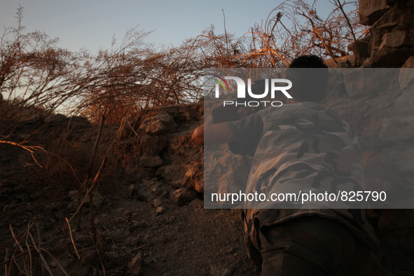 A fighter from the Free Syrian Army takes position following clashes with the pro-regime forces, in the old quarter of the northern Syrian c...