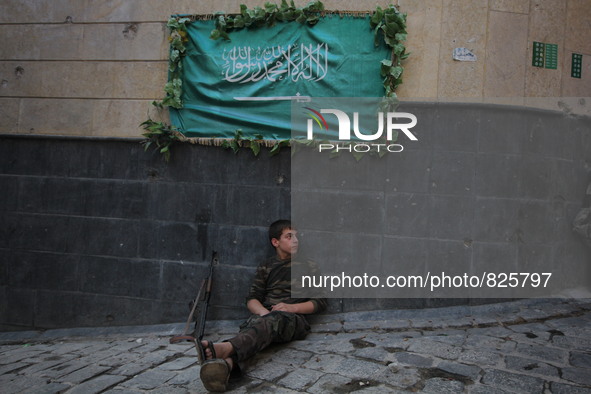 A fighter from the Free Syrian Army gets rest following clashes with the pro-regime forces, in the old quarter of the northern Syrian city o...