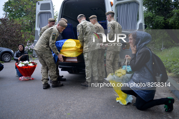 KYIV, UKRAINE - MAY 18, 2022 - Servicemen put the coffin with the body of 95th Separate Air Assault Brigade officer, Lt Denys Antipov who pe...