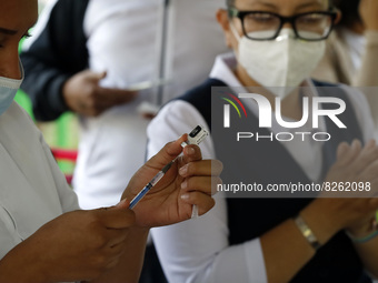 A nurse prepares the first dose of Covid19 Pfizer vaccine during mass vaccination campaign for infants 12 to 14 years of age, without comorb...