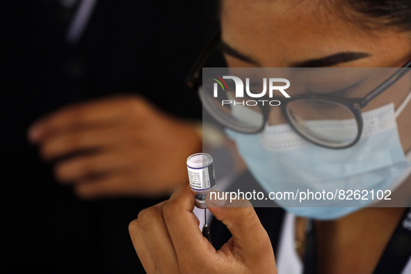 A nurse prepares the first dose of Covid19 Pfizer vaccine during mass vaccination campaign for infants 12 to 14 years of age, without comorb...