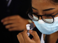 A nurse prepares the first dose of Covid19 Pfizer vaccine during mass vaccination campaign for infants 12 to 14 years of age, without comorb...