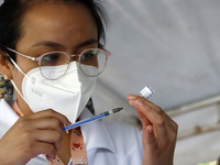 A nurse prepares the first dose of Covid19 Pfizer vaccine during mass vaccination campaign for infants 12 to 14 years of age, without comorb...