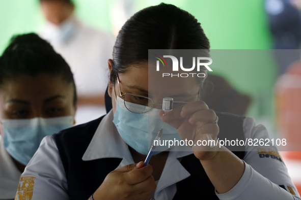 A nurse prepares the first dose of Covid19 Pfizer vaccine during mass vaccination campaign for infants 12 to 14 years of age, without comorb...