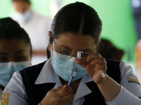 A nurse prepares the first dose of Covid19 Pfizer vaccine during mass vaccination campaign for infants 12 to 14 years of age, without comorb...