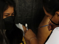 A nurse applies the first dose of Covid19 Pfizer vaccine to a child during mass vaccination campaign for infants 12 to 14 years of age, with...