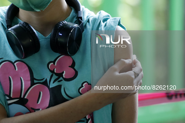 A nurse applies the first dose of Covid19 Pfizer vaccine to a child during mass vaccination campaign for infants 12 to 14 years of age, with...