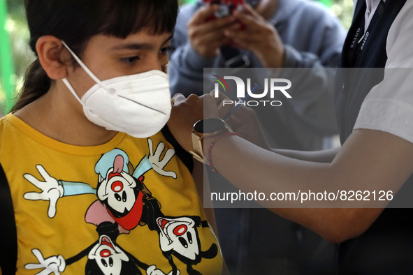 A nurse applies the first dose of Covid19 Pfizer vaccine to a child during mass vaccination campaign for infants 12 to 14 years of age, with...