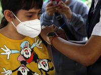 A nurse applies the first dose of Covid19 Pfizer vaccine to a child during mass vaccination campaign for infants 12 to 14 years of age, with...