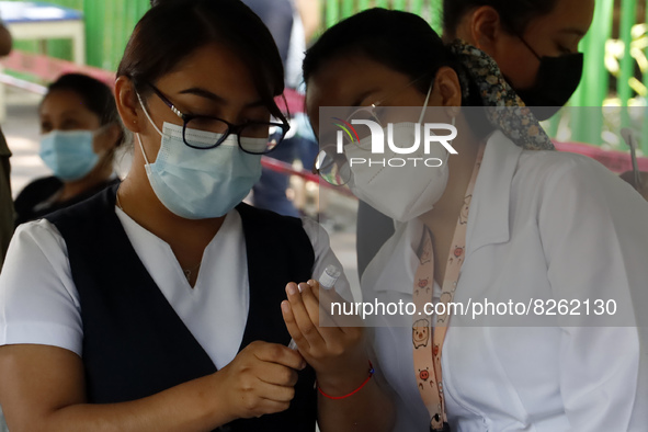 A nurse prepares the first dose of Covid19 Pfizer vaccine during mass vaccination campaign for infants 12 to 14 years of age, without comorb...