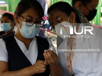 A nurse prepares the first dose of Covid19 Pfizer vaccine during mass vaccination campaign for infants 12 to 14 years of age, without comorb...