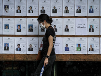 A woman looks for her name prior to casting her ballot in the Bangkok governor election at a polling station in Bangkok, Thailand, 22 May 20...