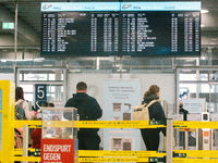 passengers are seen walking into the security checkpoint at Cologne & Bonn airport on May 25, 2022 as Germany will ease its travel restricti...