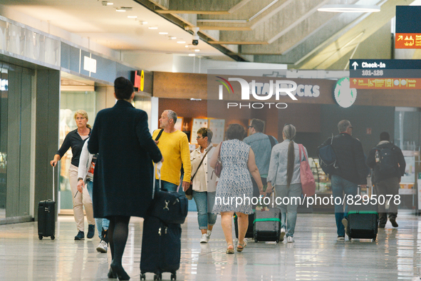 passengers are seen at Cologne & Bonn airport on May 25, 2022 as Germany will ease its travel restriction from June 1 during the summer holi...