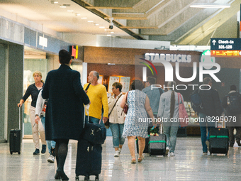 passengers are seen at Cologne & Bonn airport on May 25, 2022 as Germany will ease its travel restriction from June 1 during the summer holi...