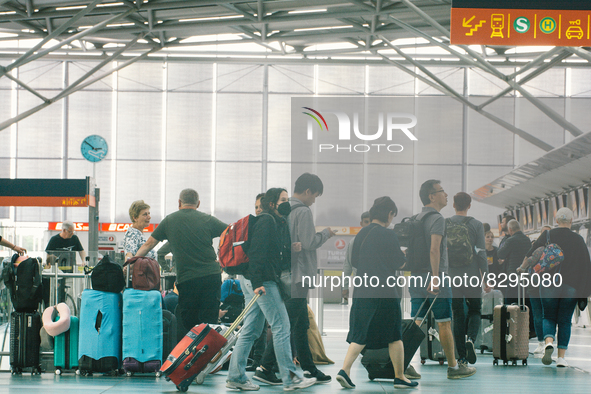 passengers are seen at Cologne & Bonn airport on May 25, 2022 as Germany will ease its travel restriction from June 1 during the summer holi...