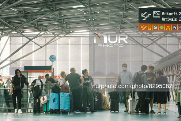 passengers are seen at Cologne & Bonn airport on May 25, 2022 as Germany will ease its travel restriction from June 1 during the summer holi...