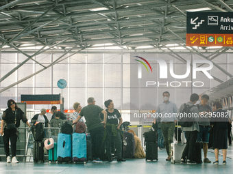 passengers are seen at Cologne & Bonn airport on May 25, 2022 as Germany will ease its travel restriction from June 1 during the summer holi...