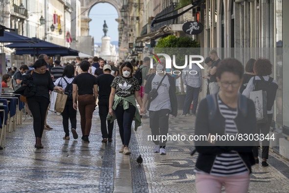 People wearing protective masks are seen walking in Augusta street, in the downtown area. Lisbon, May 23, 2022. The European Centre for Dise...