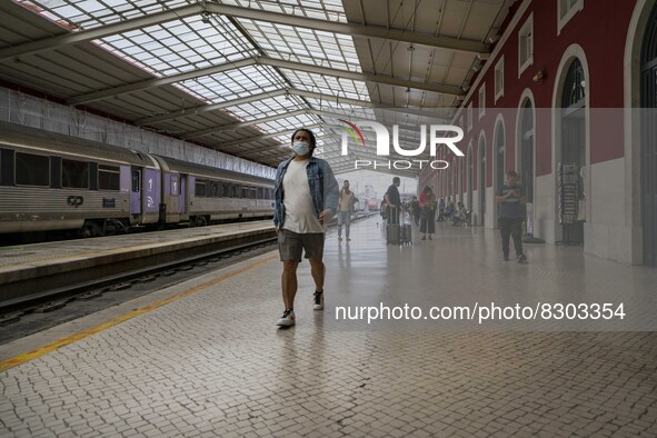 A person wearing a protective mask is seen walking inside the Santa Apolonia train station. Lisbon, May 23, 2022. The European Centre for Di...