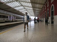 A person wearing a protective mask is seen walking inside the Santa Apolonia train station. Lisbon, May 23, 2022. The European Centre for Di...