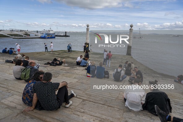 People are seen carrying out outdoor activities near the banks of the Tejo river, in Cais Das Colunas. Lisbon, May 23, 2022. The European Ce...