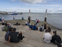 People are seen carrying out outdoor activities near the banks of the Tejo river, in Cais Das Colunas. Lisbon, May 23, 2022. The European Ce...