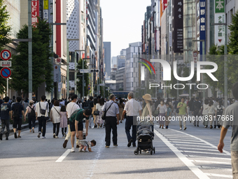 People walk and enjoy on a pedestrian mall at Ginza in Tokyo, Japan on 29 May. (