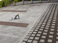 A toddler plays with his mother at a deserted plaza in Yokohama, Japan on 27 May. (