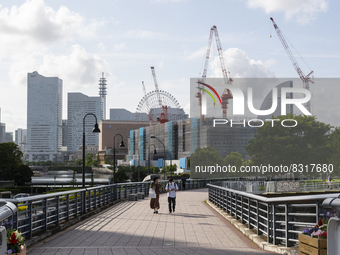 Couple with a parasol walk at seaside urban area in Yokohama, Japan on 27 May. (