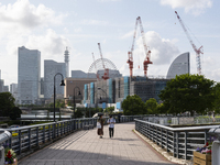 Couple with a parasol walk at seaside urban area in Yokohama, Japan on 27 May. (