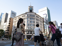 People walk and enjoy on a pedestrian mall at Ginza in Tokyo, Japan on 29 May. (