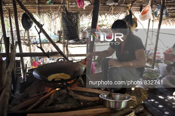 Nor Sila(22) is cooking for dinner. Egg fries are made on wood fire Malaysia is one of the most fast developing country nevertheless , the m...