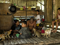 Mak Bakok(28) and Ayah Bakok(30) are  having lunch with their children. From right Katalina(10), Bulan(7), Mera(8) and Samut(9). Malaysia is...