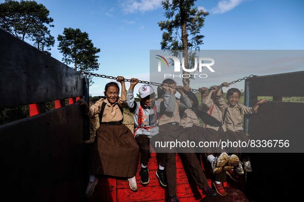 Students are huddling together in a truck to going school in Tugu Utara Village, Regency Bogor, West Java province, Indonesia on 2 June, 202...