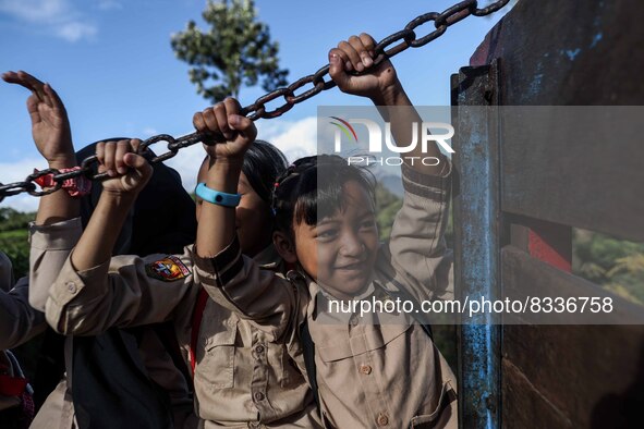 Students are huddling together in a truck to going school in Tugu Utara Village, Regency Bogor, West Java province, Indonesia on 2 June, 202...